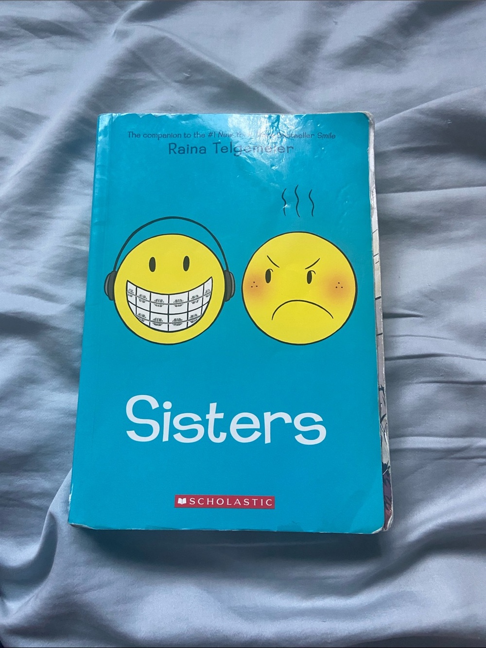 Scholastic Sisters — Teal Cover with Yellow Emoji Faces